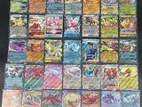 a large collection of pokemon cards are displayed on a table