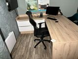 a desk with a chair and a computer on it