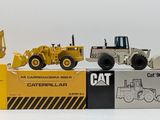 a lot of toy construction vehicles on display on a white surface