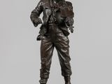 a bronze statue of a man with a hat on his head