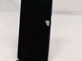 a close up of a cell phone on a stand on a white surface
