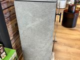 a refrigerator that is sitting on the floor in a store