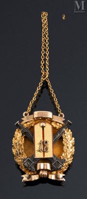 a gold and black clock hanging from a gold chain