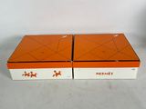 pair of orange and white boxes with stars on them sitting on a table