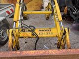 a yellow bulldozer sitting in the middle of a parking lot