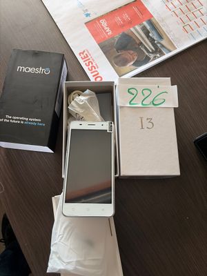 a white cell phone sitting in a box on a table