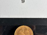 a close up of a gold coin in a box on a table
