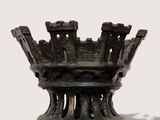a black vase that has a crown on top of it