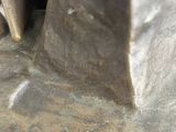 a close up of a statue of a person with a knife