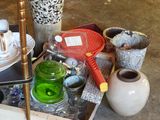 a cart full of vases and other items on the floor