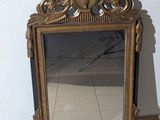 a mirror that is sitting on the floor in front of a wall