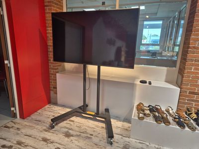 a flat screen tv sitting on a stand in a room