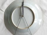 a white plate with a clock on it sitting on a table
