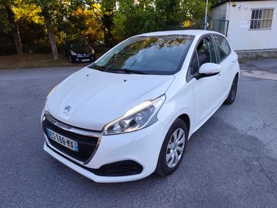 La voiture blanche est garée dans la rue, devant une maison.