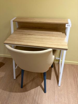 un bureau avec une chaise devant, dans une pièce