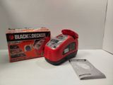 a small red and black and decker air compressor next to a box