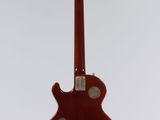 a red guitar hanging from the ceiling