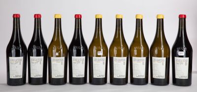 six bottles of wine lined up in a row on a table