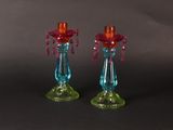 pair of colorful glass candlesticks on a black background