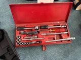 a red tool box with tools in it on the floor