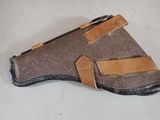 an image of a brown leather holster with a pen in it