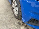 a close up of a blue car that has been dented