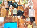 many bottles of perfume on a table with a price tag