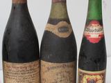 several bottles of wine are lined up on a white surface