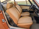 an orange car with tan leather seats in the back of it