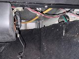 a car that has some wires in the trunk of it