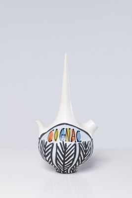 small ceramic teapot with hand painted design on the top