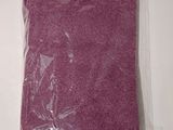 a close up of a purple towel in a bag on a table