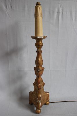 brass plated table lamp with a cone shade on top of a wooden base