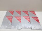 six boîtes de manettes de jeu Nintendo Wii posées sur une table blanche