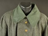 an image of a green coat with buttons on it