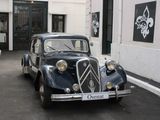 a vintage car parked on the side of the street