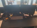 a desk with two computer monitors and a keyboard on it