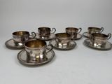six silverplated cups and saucers with saucers and saucers