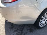 a close up of a car ' s rear end with the door open