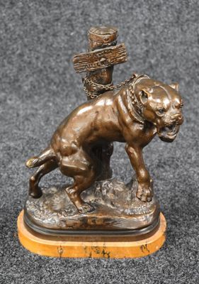 bronze statue of a dog with a basket on its head