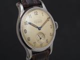 a close up of a wrist watch with a brown leather strap