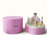 chanel perfume bottle in a pink box on a white surface