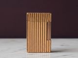 un briquet en or posé sur un plan de travail en marbre