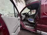 a red van with the door open next to a white van