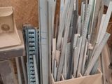 several pieces of metal are stacked up in a bin on the floor