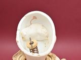 a figurine of a woman with a bowl on her head