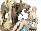 a figurine of a man and a woman sitting on a donkey
