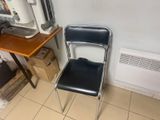 a chair that is next to a desk in a room