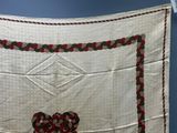 a white cloth with a red and green design on it
