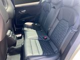 the back seats of a car with a black leather seat cover